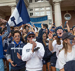 Students cheering at a game. Link to Gifts by Estate Note